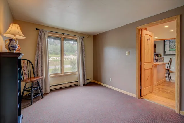 an empty room with furniture and a flat screen tv