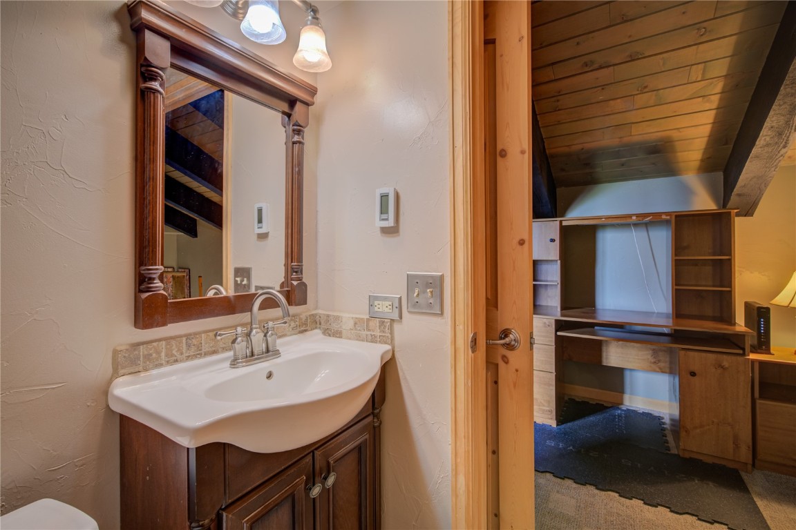 1945 Cornice Road, Unit 2431 Steamboat Springs, CO 80487 - Photo 10 of 24 a bathroom with a sink and a mirror