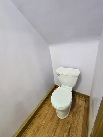 a white toilet sitting next to a sink