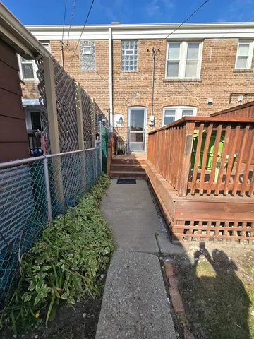 a view of a balcony with wooden floor and fence