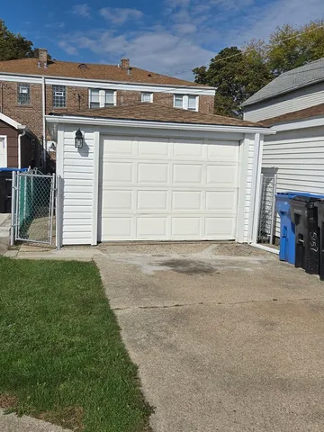 a view of a house with a yard and garage