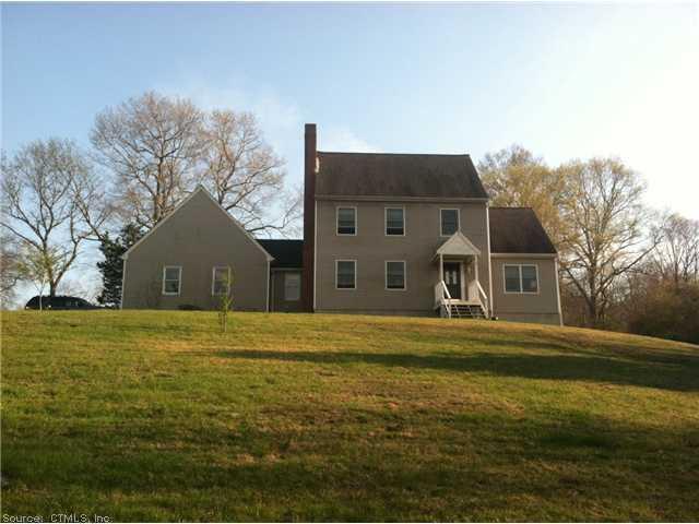 115 Long Hill Road Clinton, CT 06413 - Photo 1 of 1 a front view of house with yard and trees