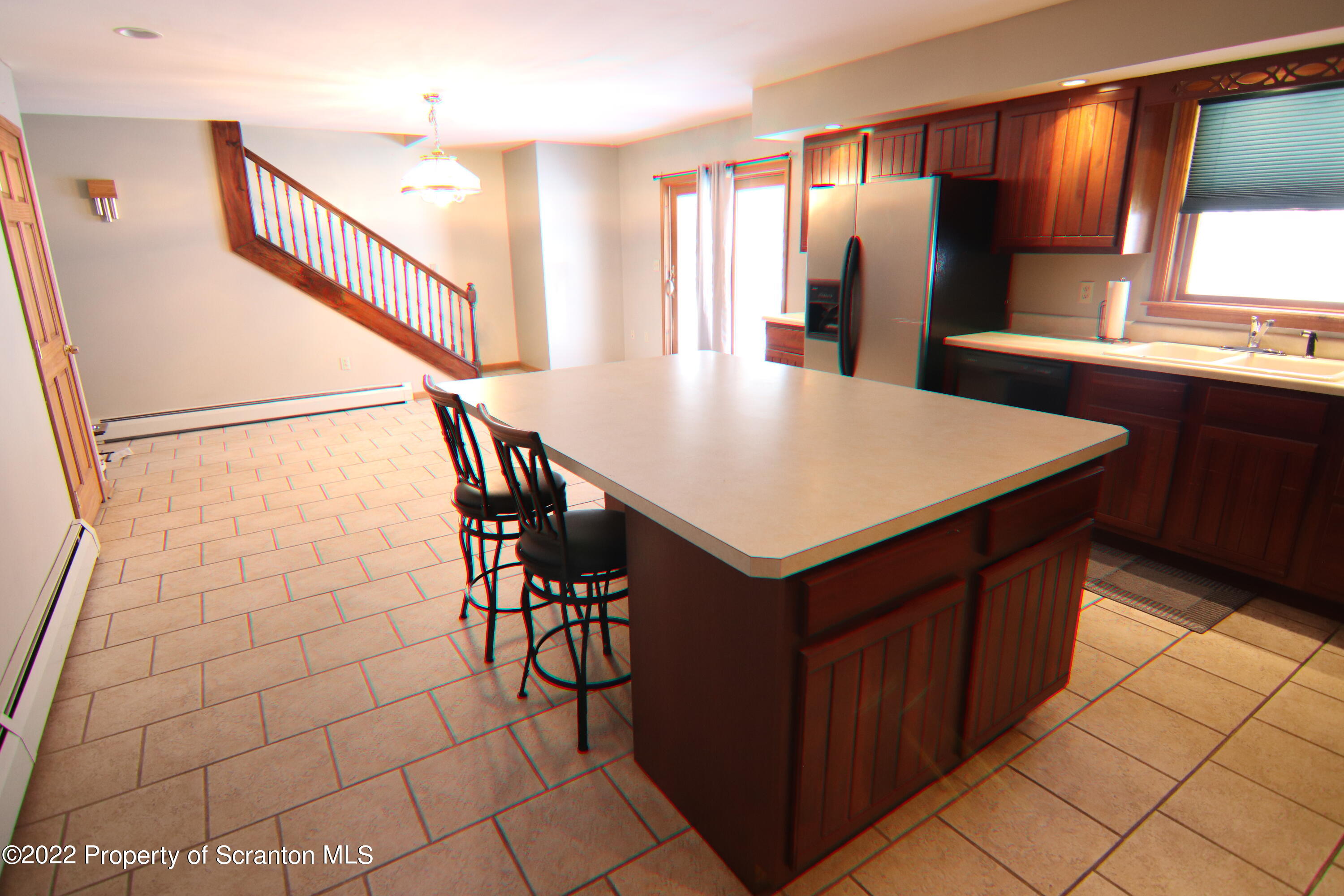 255 Billings Mill Road Tunkhannock, PA 18657 - Photo 17 of 47 a kitchen with a sink a refrigerator and chandelier