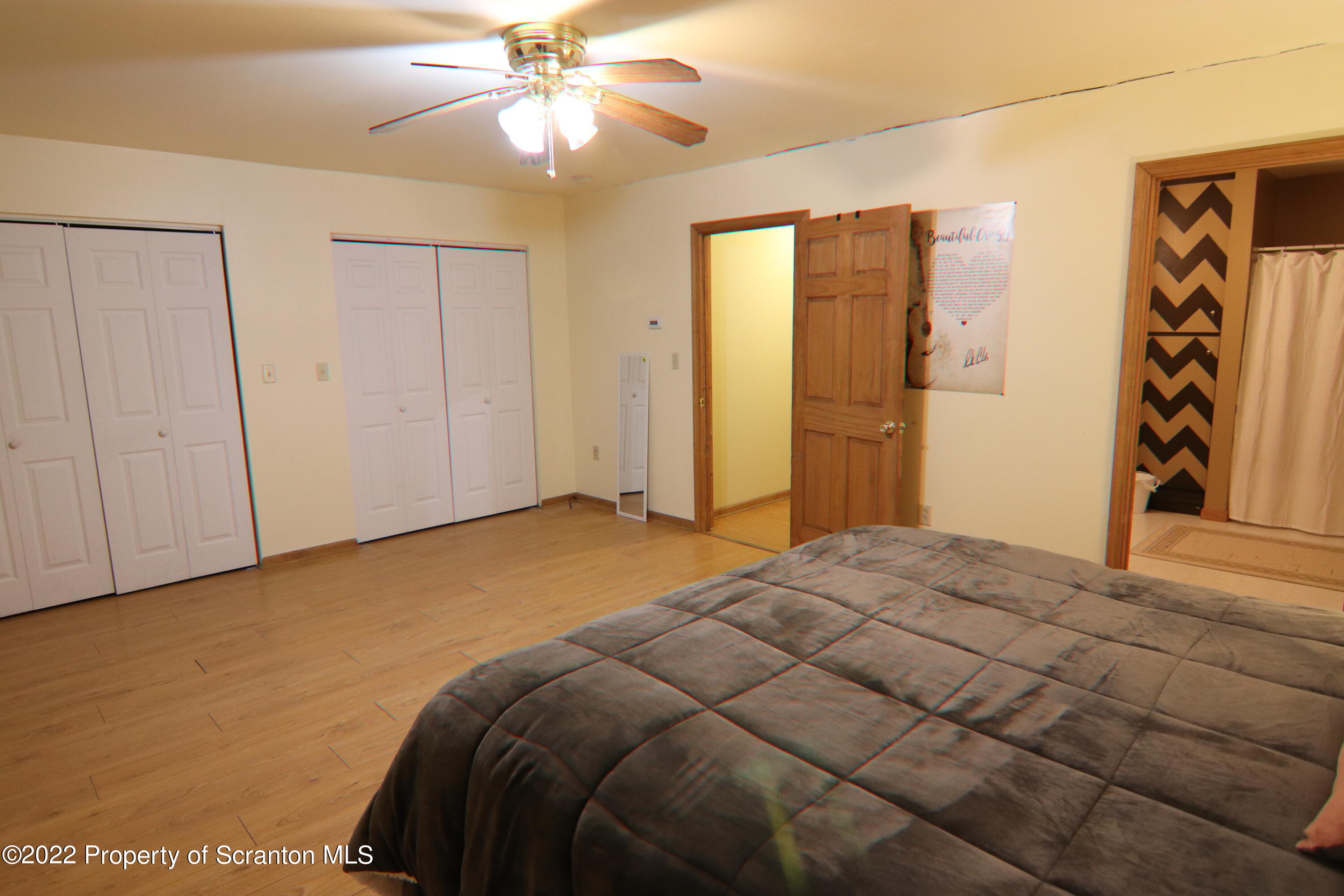 255 Billings Mill Road Tunkhannock, PA 18657 - Photo 25 of 47 a bedroom with a large bed and a chandelier