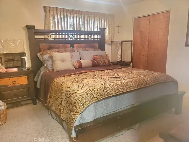 a bed sitting in a bedroom next to a window