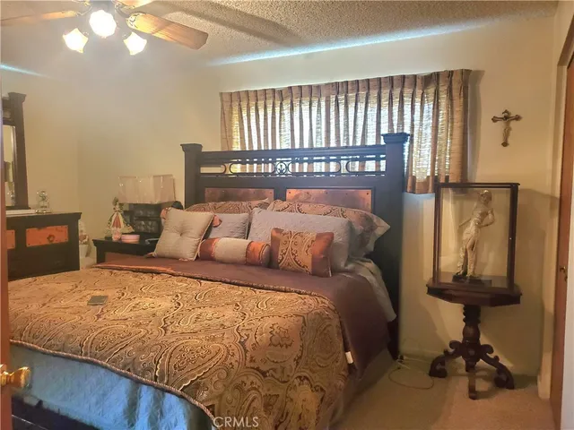 a bed sitting in a bedroom next to a window