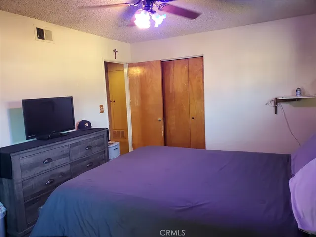 a bed room with a bed and a television