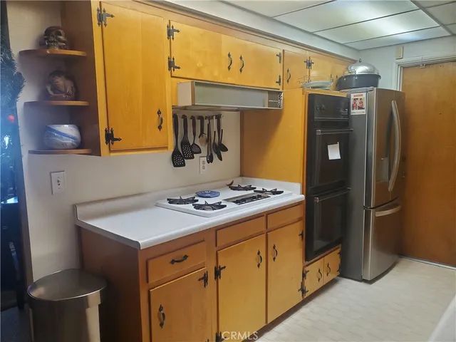 a kitchen with a refrigerator and a stove