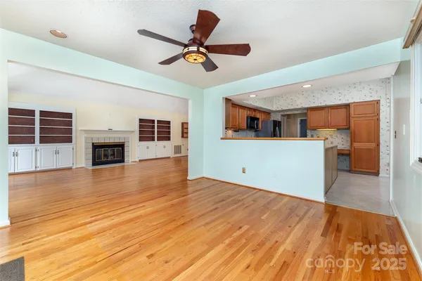a view of a livingroom with a fireplace and wooden floor