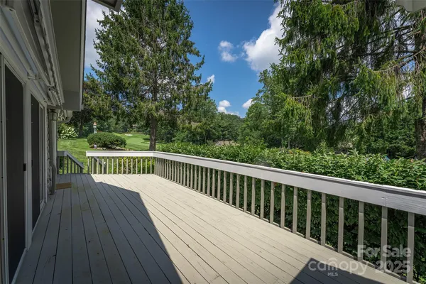 a balcony with wooden floor and fence
