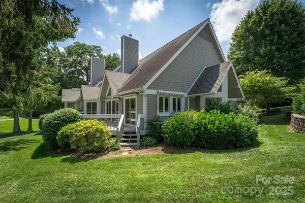 a view of a house with a yard and plants