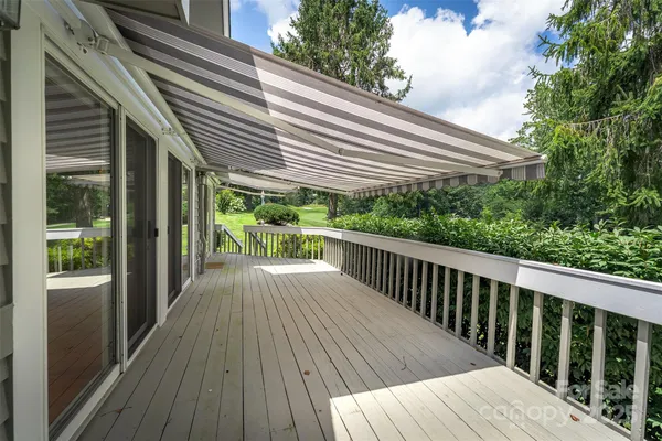 a view of backyard with deck and wooden floor