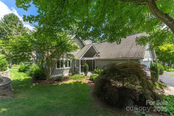 a front view of house with a garden