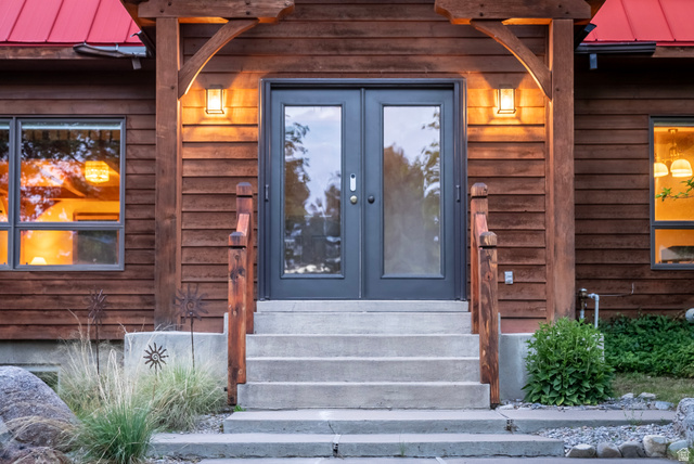 435 Canyon Road Millville, UT 84326 - Photo 4 of 113 Entryway featuring dark-framed double doors with glass panels, concrete steps, and wooden handrails