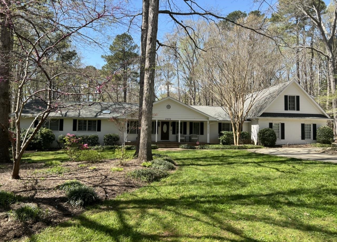 5408 Amsterdam Place Raleigh, NC 27606 - Photo 1 of 4 a front view of a house with a yard