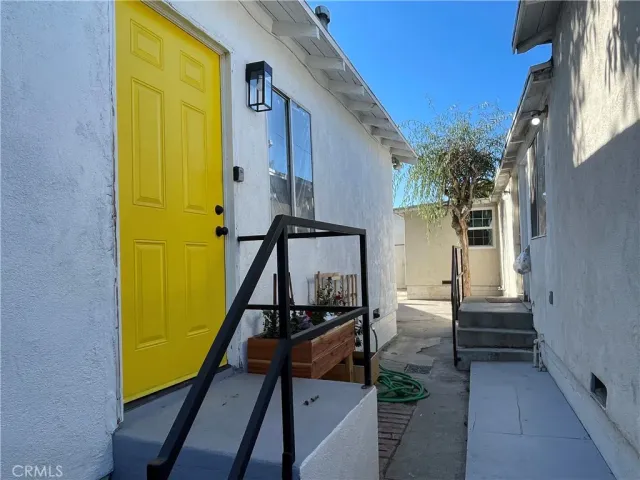a view of a staircase and wooden door