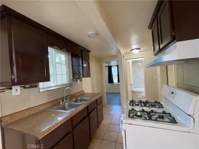a kitchen with a sink stove and cabinets