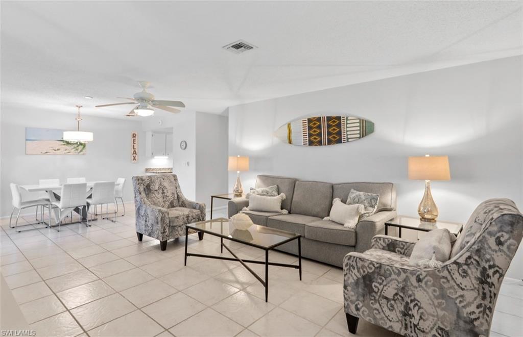 136 Harrison Road, Unit 1 Naples, FL 34112 - Photo 5 of 29 Open-concept living and dining area featuring tile flooring throughout