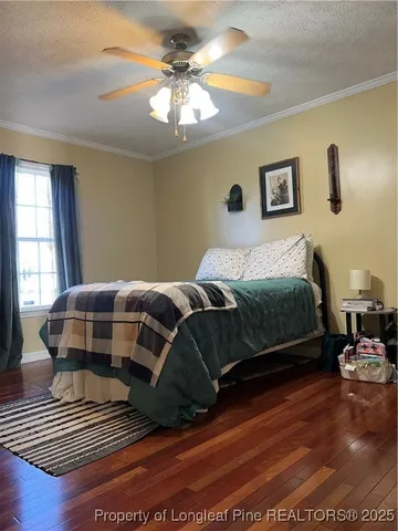 a bedroom with a bed lamp and a window