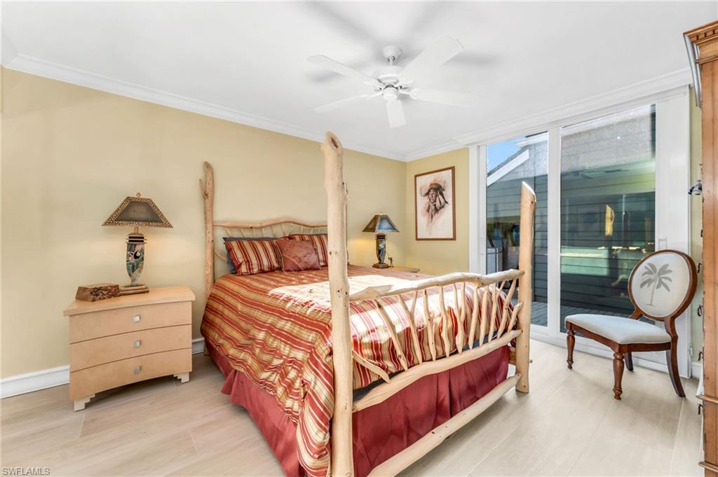 667 Bridge Way Lane Naples, FL 34108 - Photo 11 of 18 a bedroom with a bed and lamp chandelier