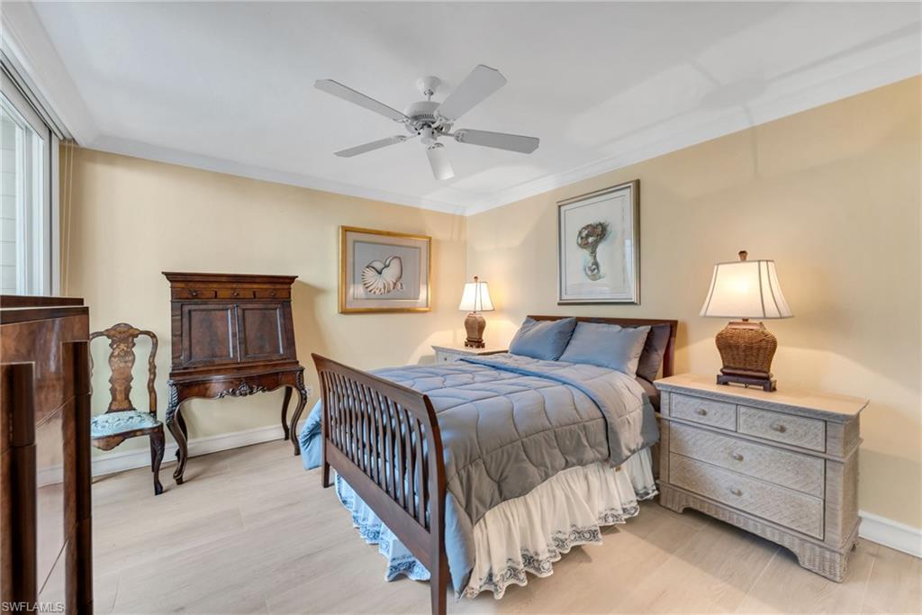 667 Bridge Way Lane Naples, FL 34108 - Photo 13 of 18 a bedroom with a bed and a chandelier