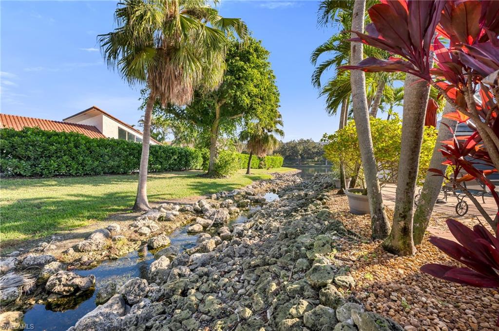 667 Bridge Way Lane Naples, FL 34108 - Photo 2 of 18 a view of a yard with plants and large trees