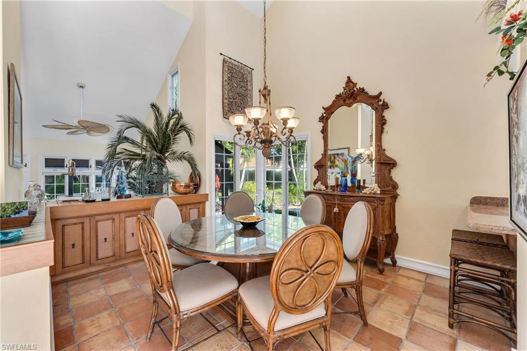 667 Bridge Way Lane Naples, FL 34108 - Photo 8 of 18 a view of a dining room with furniture window and wooden floor