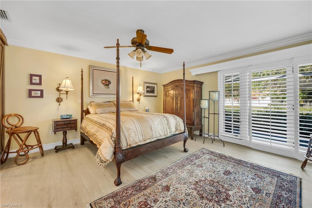667 Bridge Way Lane Naples, FL 34108 - Photo 9 of 18 a bedroom with a bed a chair and dresser next to a window