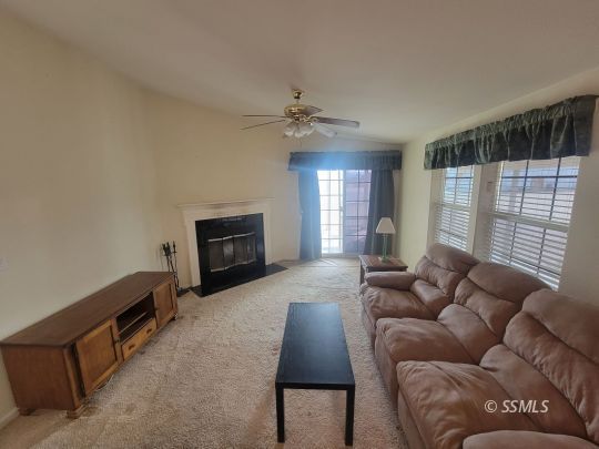 747 North Charles Street Ridgecrest, CA 93555 - Photo 3 of 23 a living room with furniture and a fireplace