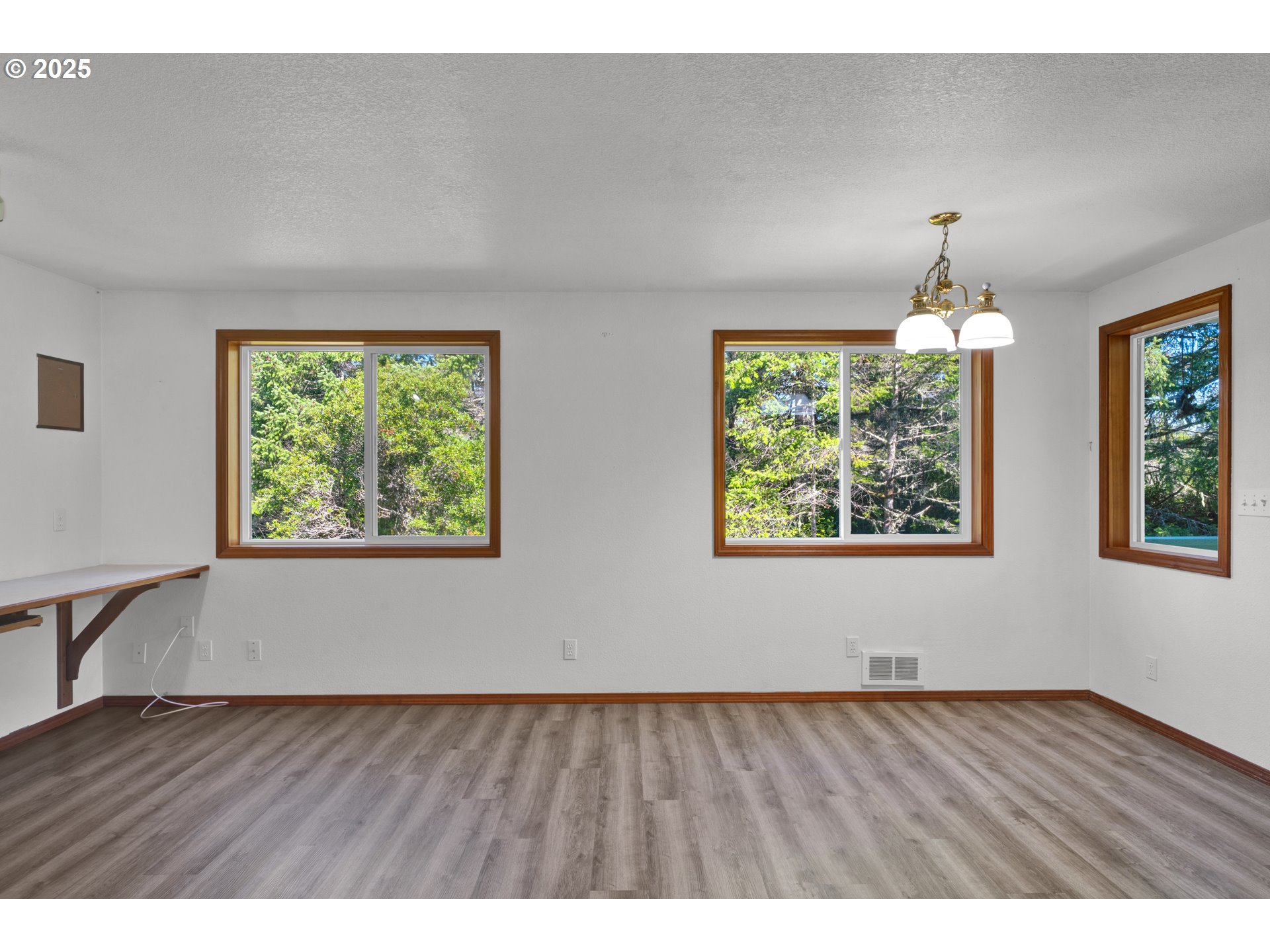 5603 Friendly Acres Road Florence, OR 97439 - Photo 11 of 45 wooden floor in an empty room with a window