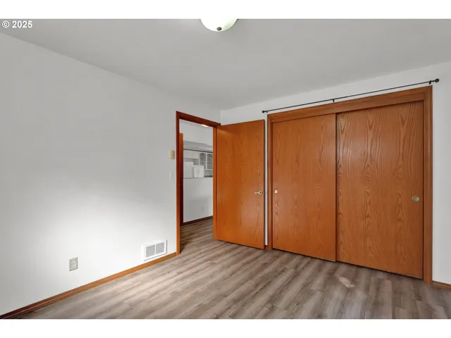 a view of an empty room and wooden floor