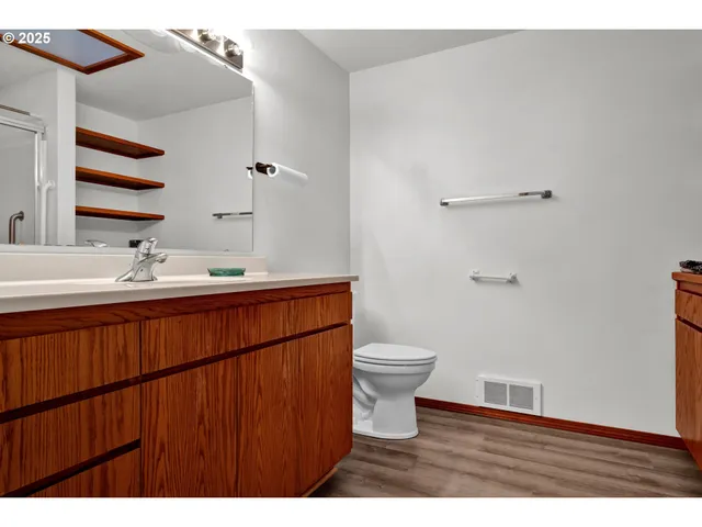 a bathroom with a sink a toilet and a mirror