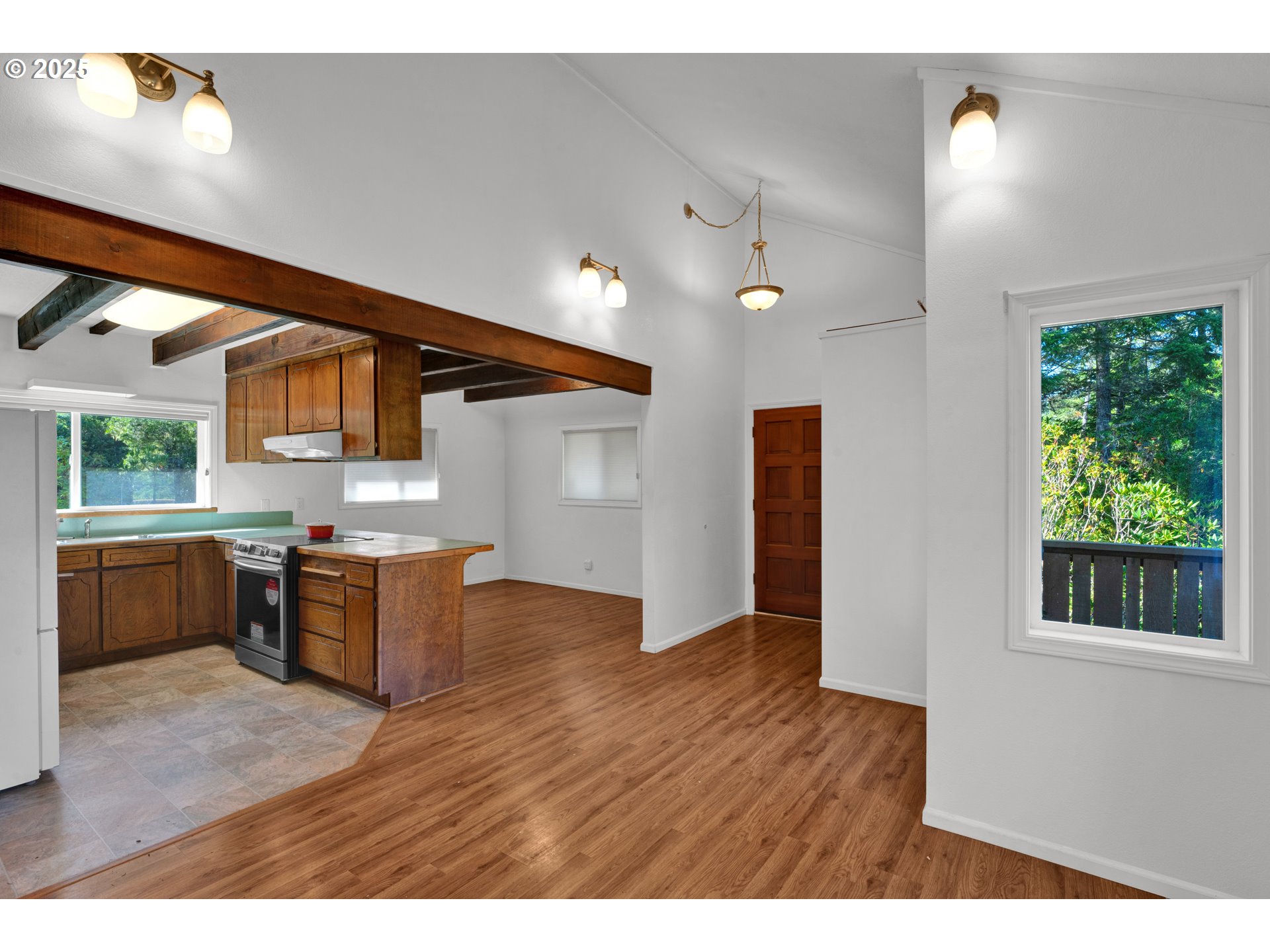5603 Friendly Acres Road Florence, OR 97439 - Photo 17 of 45 a kitchen with kitchen island a counter top space a sink stainless steel appliances and cabinets