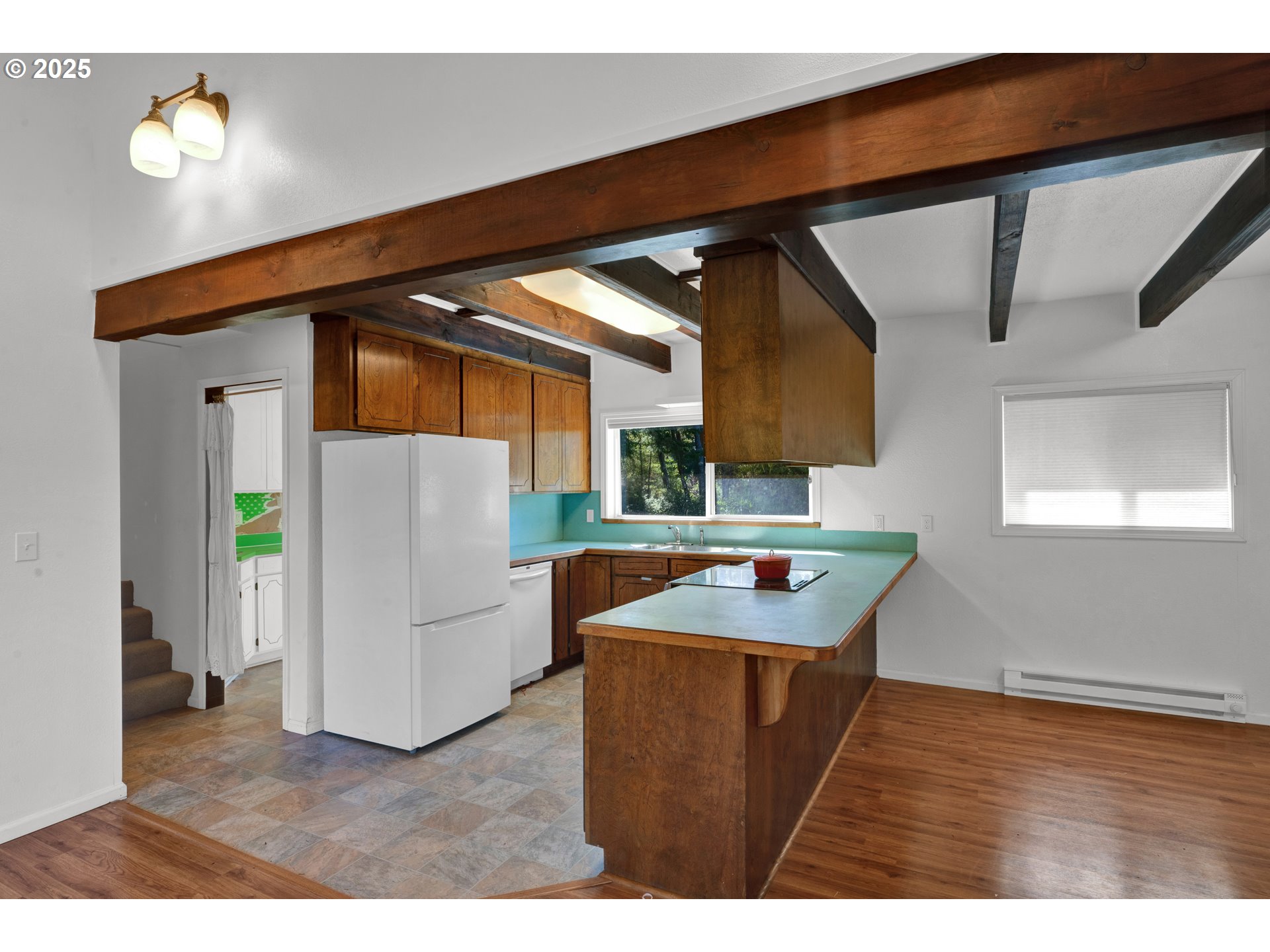 5603 Friendly Acres Road Florence, OR 97439 - Photo 18 of 45 a kitchen that has a sink and a wooden floor