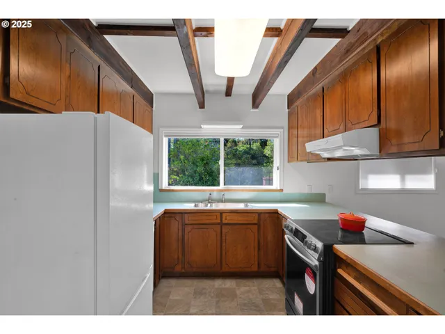a kitchen with stainless steel appliances a sink and a cabinets