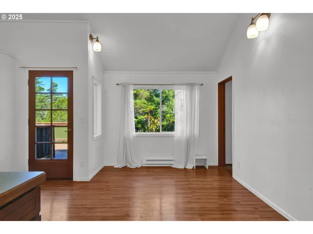 a view of room with hardwood floor and window