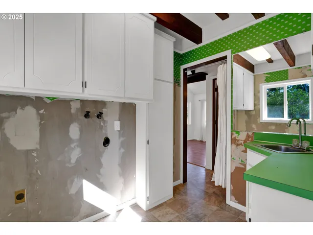 a view of a bathroom with a shower and a sink