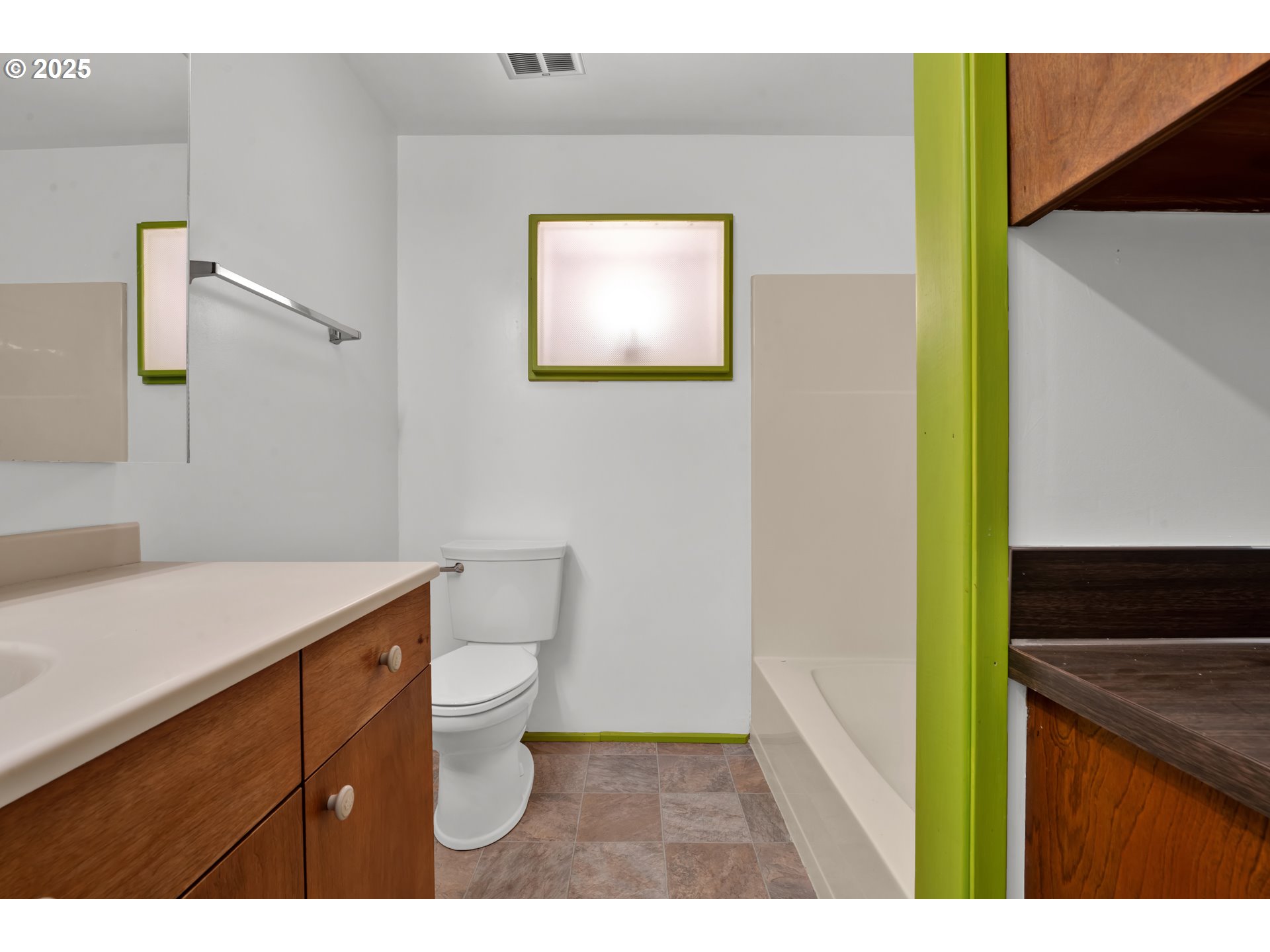 5603 Friendly Acres Road Florence, OR 97439 - Photo 25 of 45 a bathroom with a sink a toilet a vanity and mirror