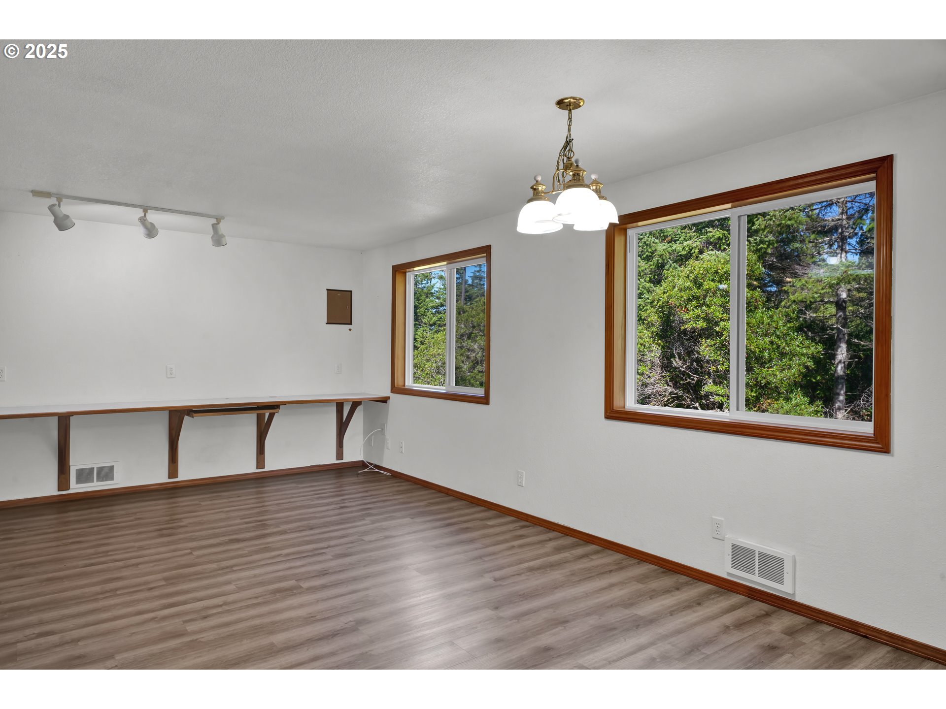 5603 Friendly Acres Road Florence, OR 97439 - Photo 7 of 45 a view of an empty room with wooden floor and a window