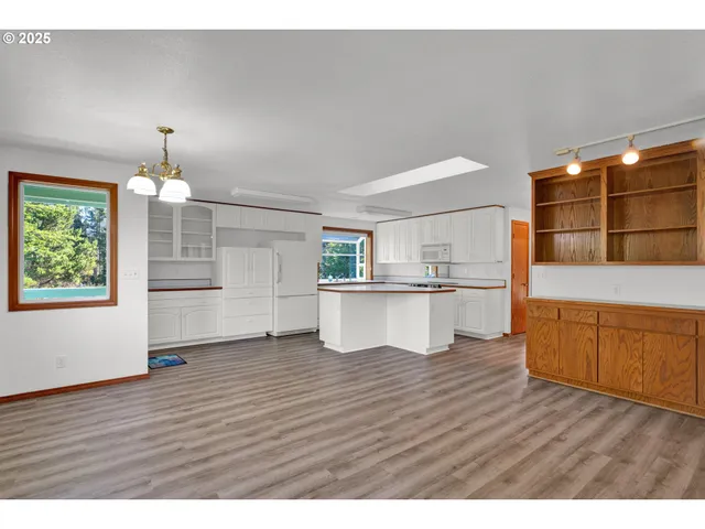 a view interior of kitchen and hall with wooden floor