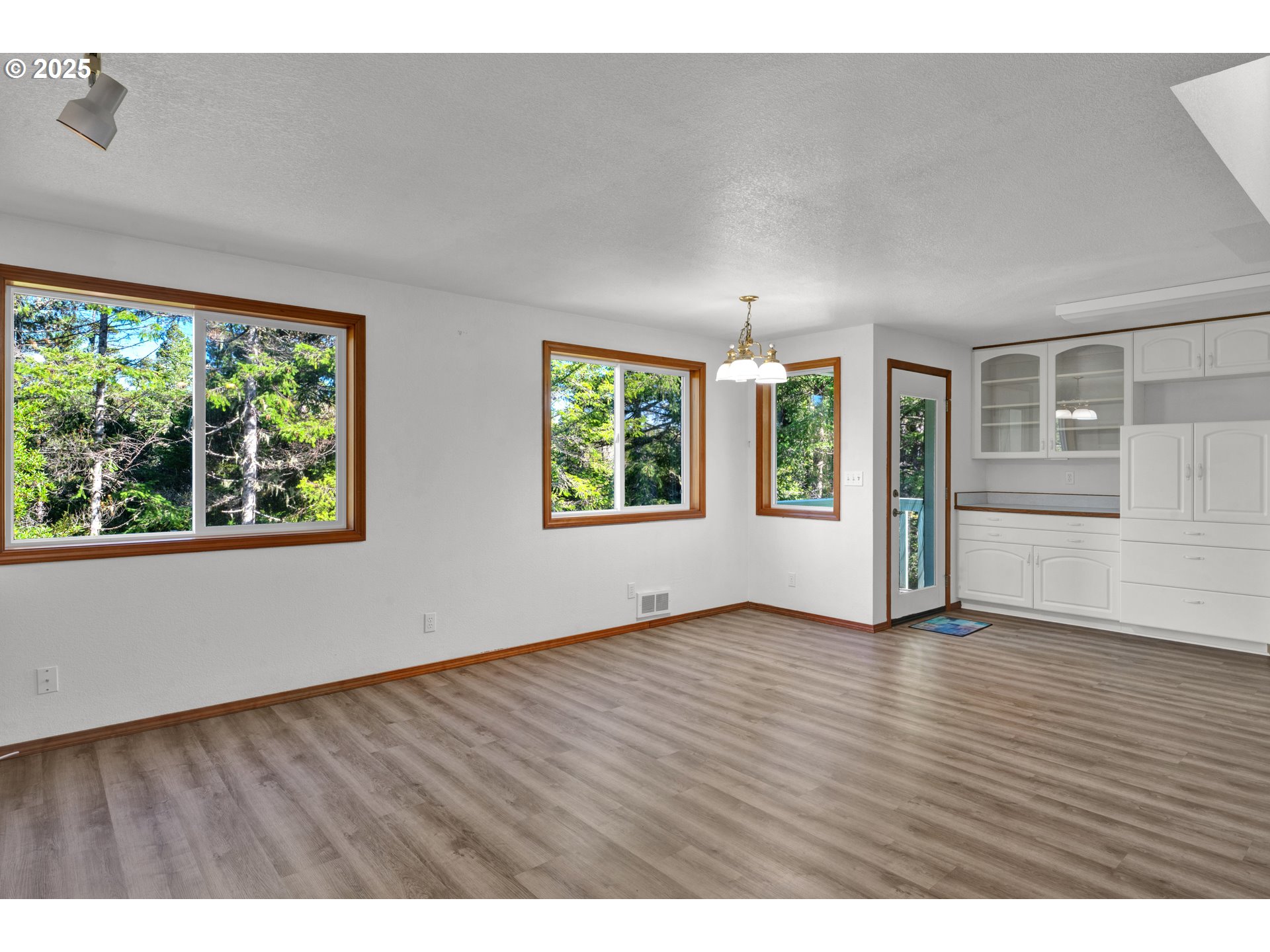5603 Friendly Acres Road Florence, OR 97439 - Photo 10 of 45 an empty room with wooden floor and windows