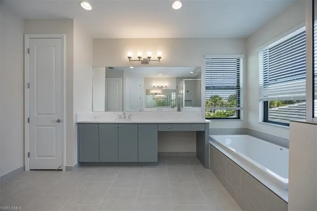 a large spacious bathroom with a large tub and sink