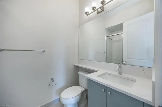 a bathroom with a sink toilet and vanity