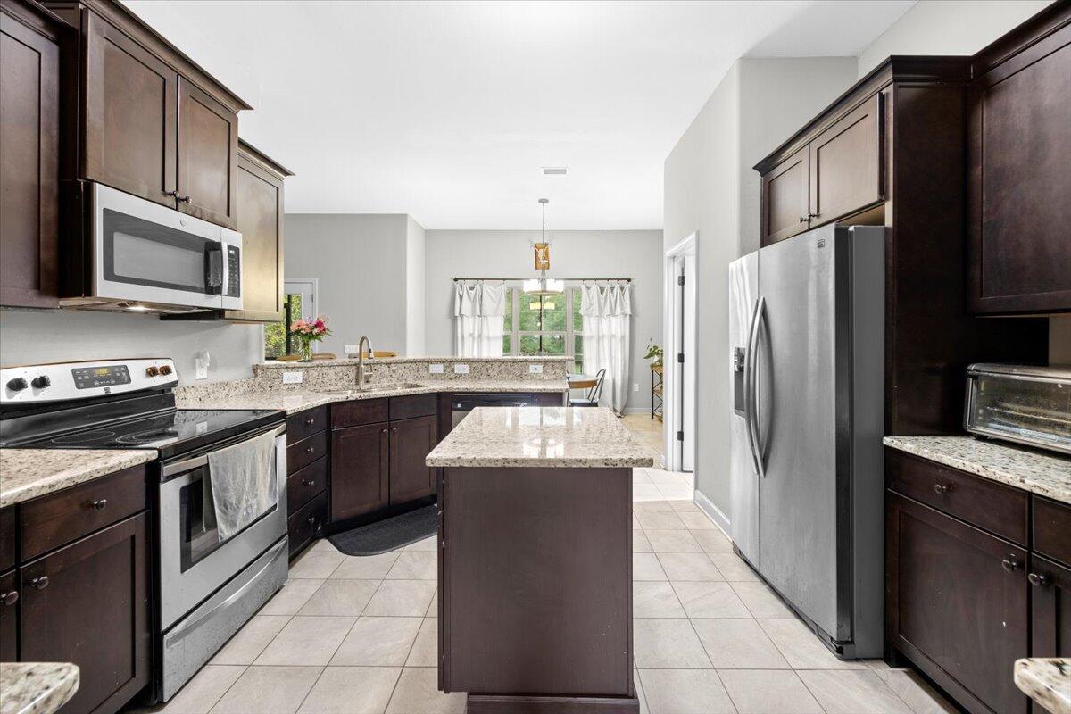 6057 Diamante Drive Crestview, FL 32539 - Photo 12 of 33 a kitchen with stainless steel appliances granite countertop a refrigerator stove microwave and sink