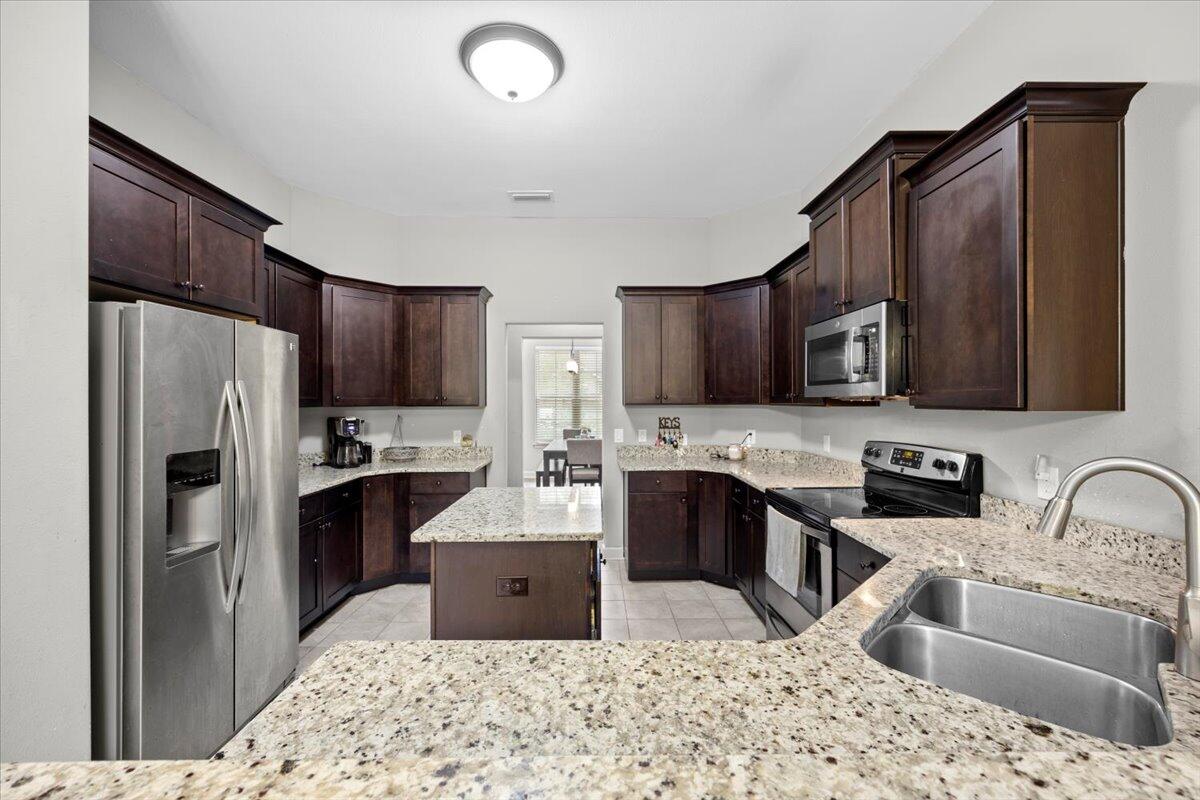 6057 Diamante Drive Crestview, FL 32539 - Photo 13 of 33 a kitchen with stainless steel appliances granite countertop a refrigerator stove microwave and sink