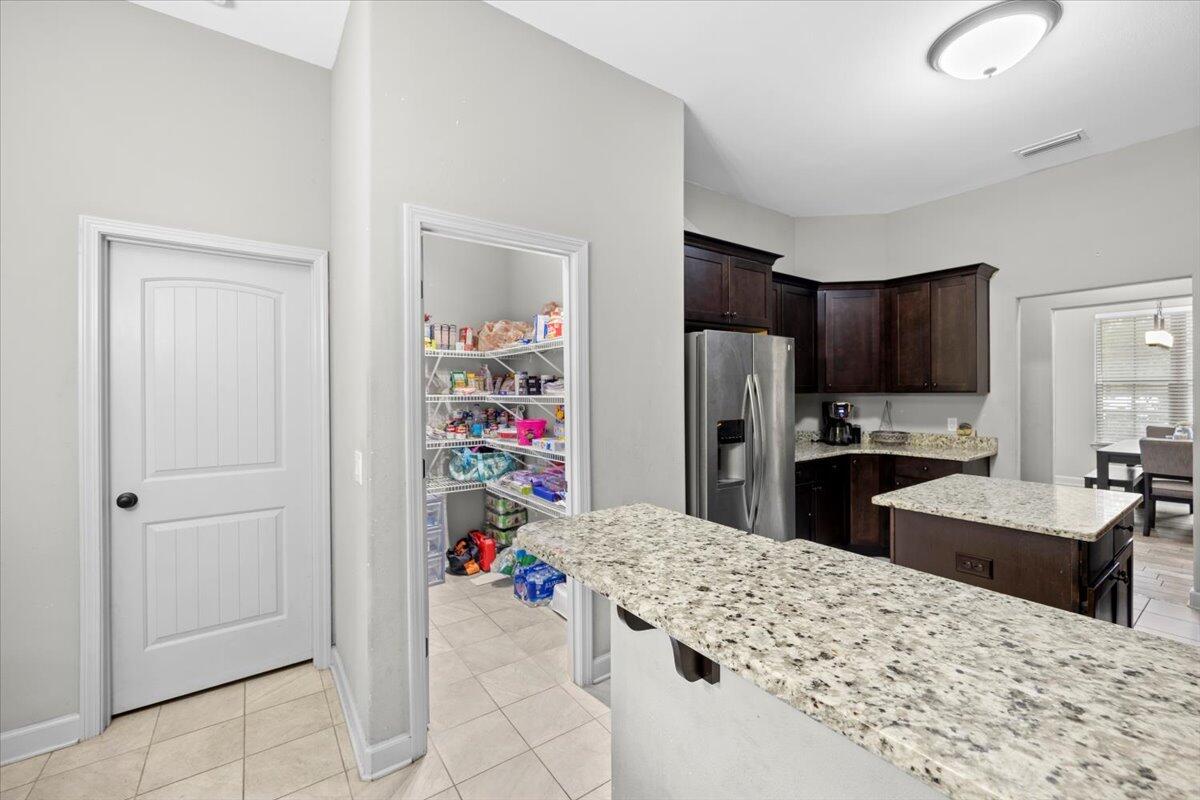 6057 Diamante Drive Crestview, FL 32539 - Photo 14 of 33 a kitchen with refrigerator and cabinets