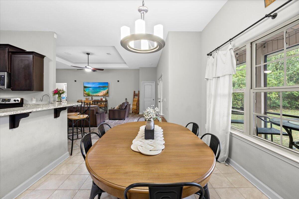 6057 Diamante Drive Crestview, FL 32539 - Photo 16 of 33 a view of a dining room with furniture a chandelier and wooden floor