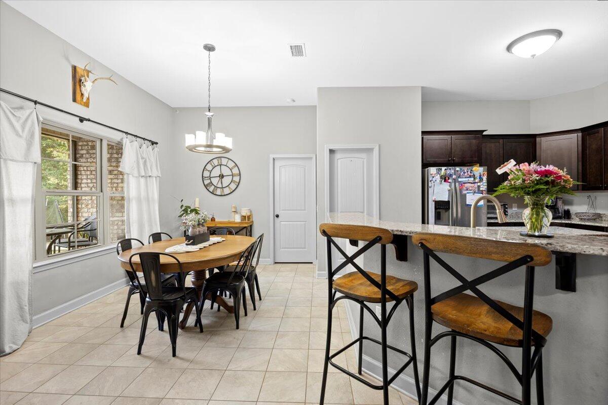 6057 Diamante Drive Crestview, FL 32539 - Photo 17 of 33 a view of a dining room with furniture window and wooden floor