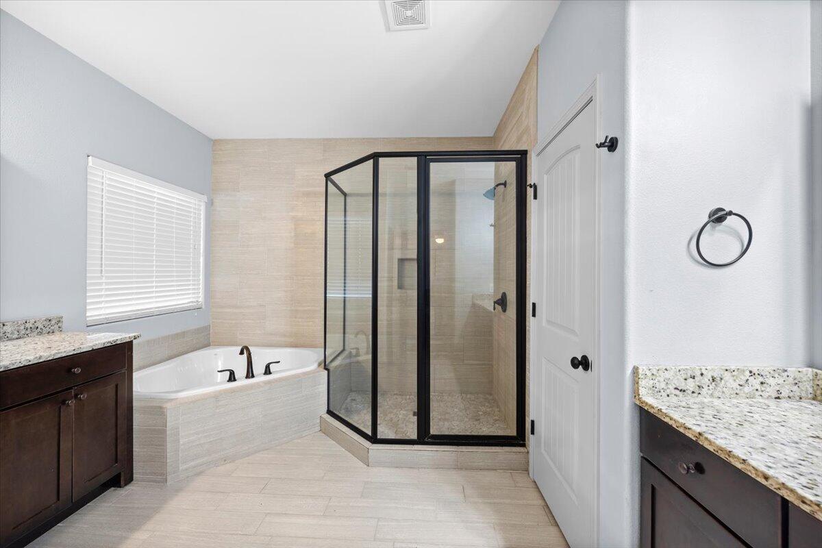 6057 Diamante Drive Crestview, FL 32539 - Photo 19 of 33 a spacious bathroom with a tub shower and mirror