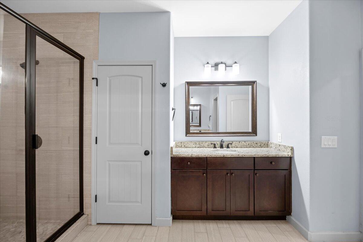 6057 Diamante Drive Crestview, FL 32539 - Photo 22 of 33 a bathroom with a granite countertop sink and a mirror